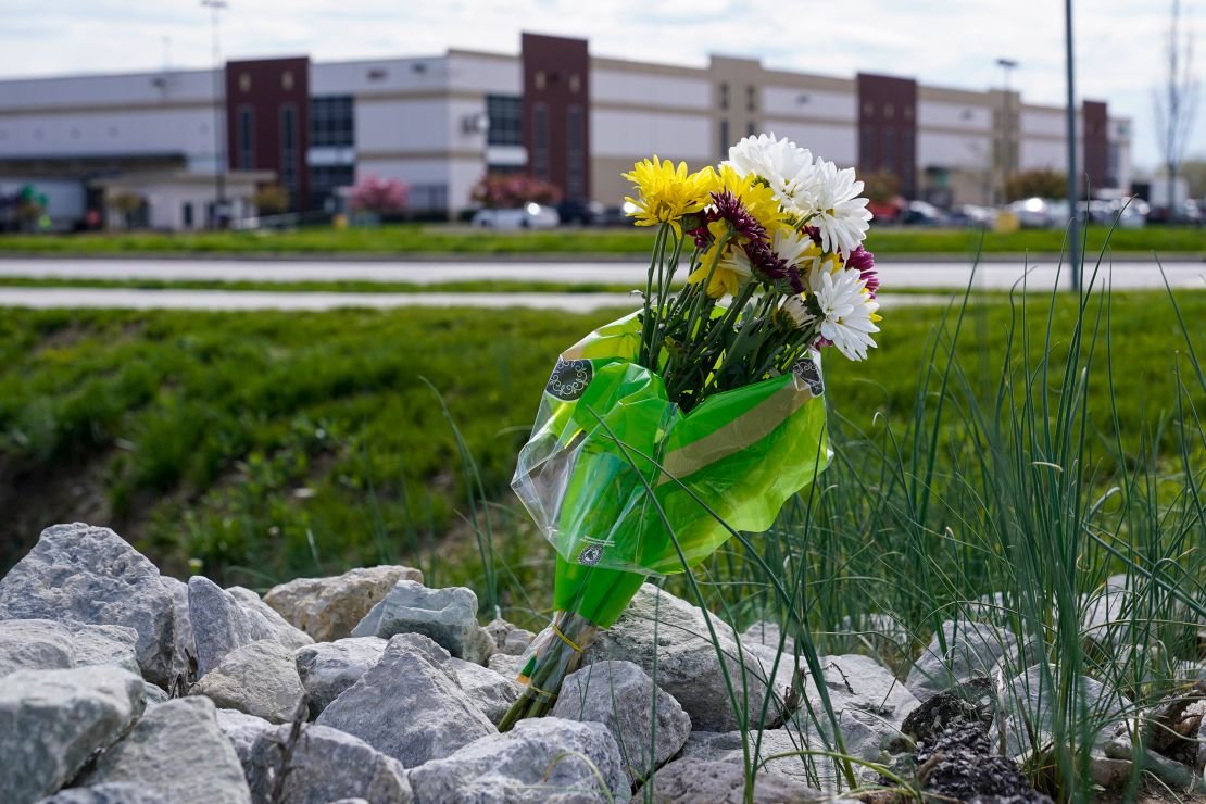A single bouquet of flowers sits in the rocks across the street from the FedEx facility in Indianapolis, April 17, 2021, where eight people were shot and killed. 