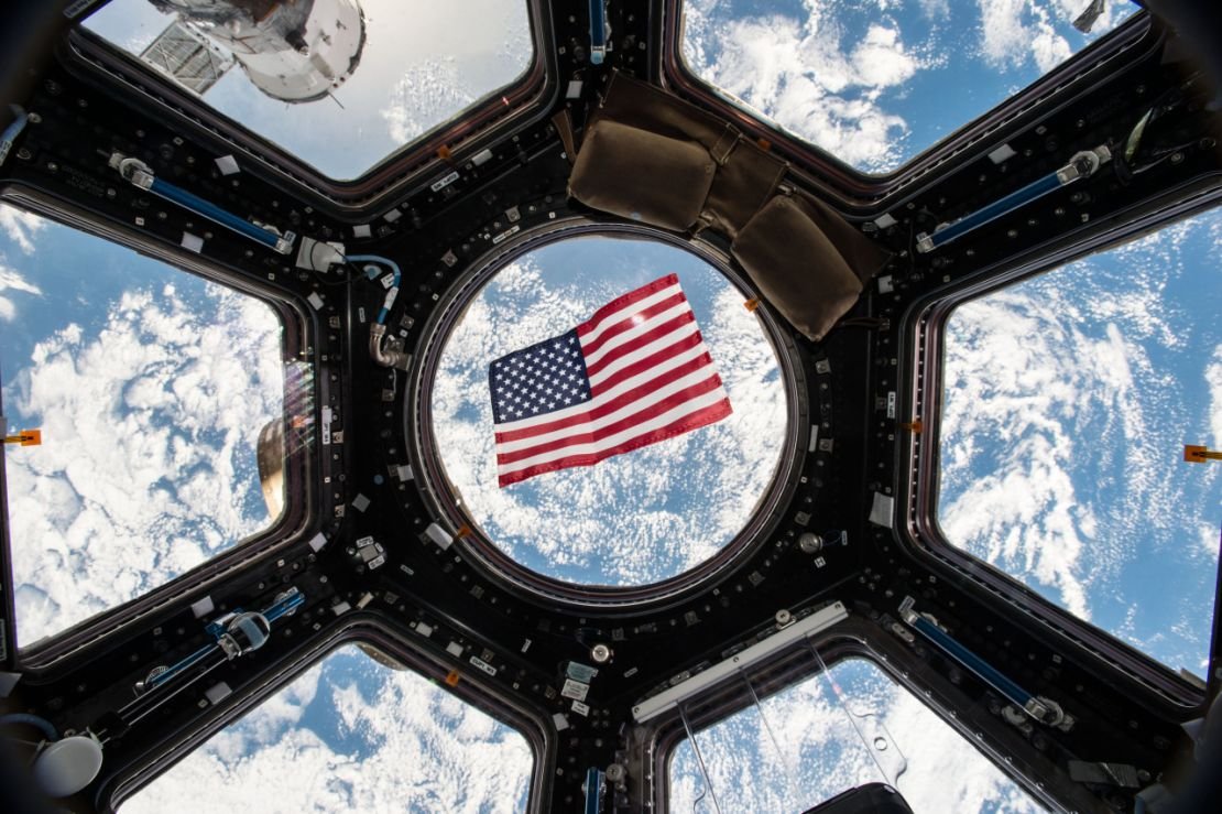 Image Kjell Lindgren released on social media of the US flag floating in the Cupola module. 